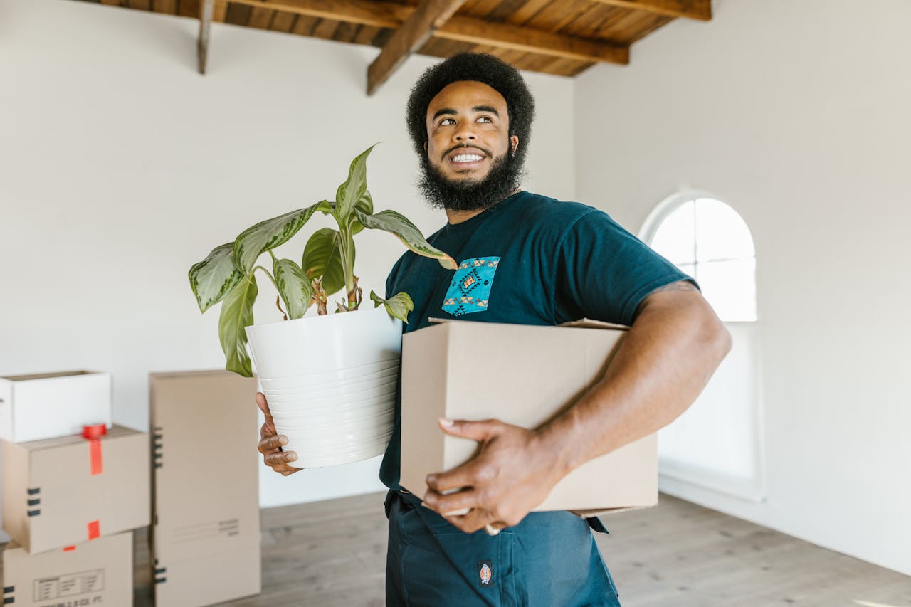 Man in Blue Crew Neck T-shirt Holding White Paper